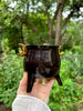 Black handmade ceramic cauldron with moon handles in copper lustre